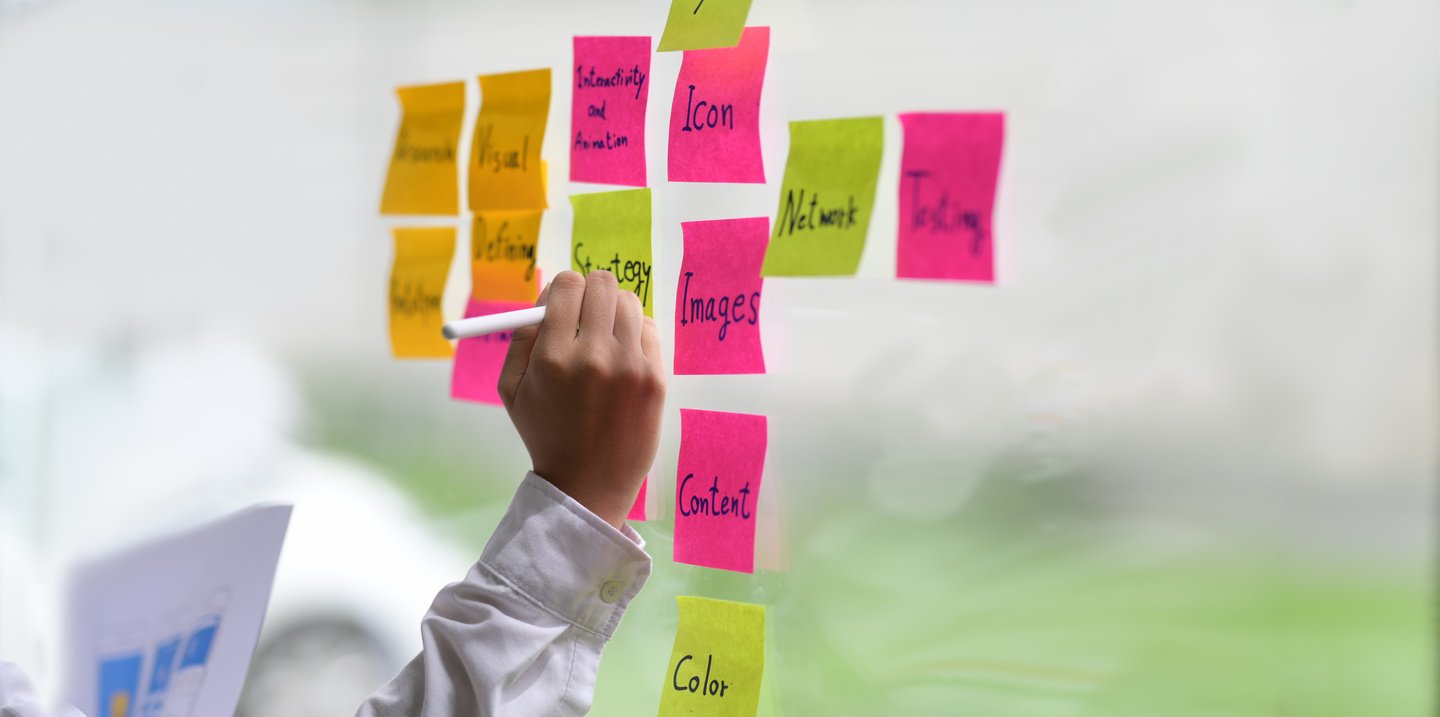 Person Writing on Sticky notes